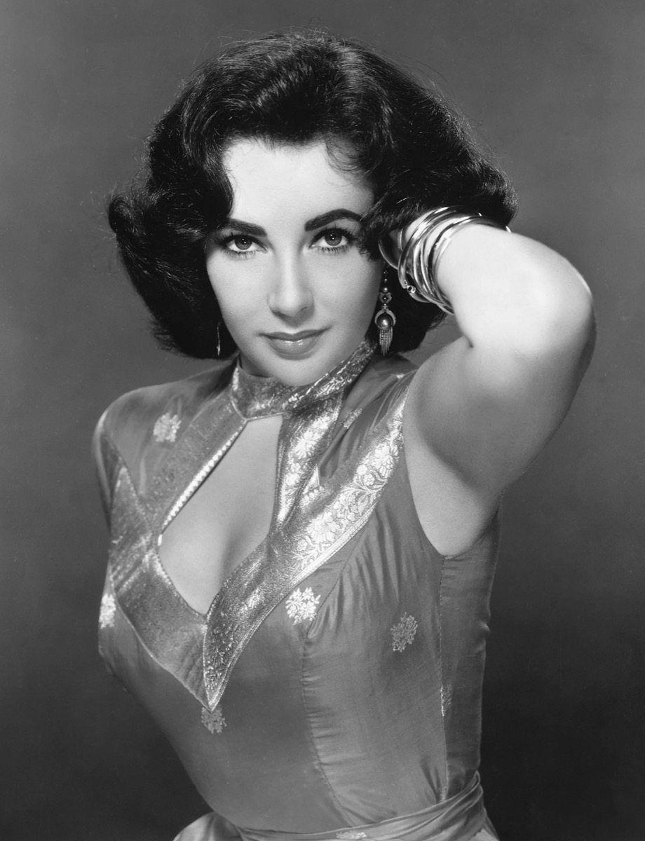 Elizabeth Taylor: Metallic halter gown and bangles