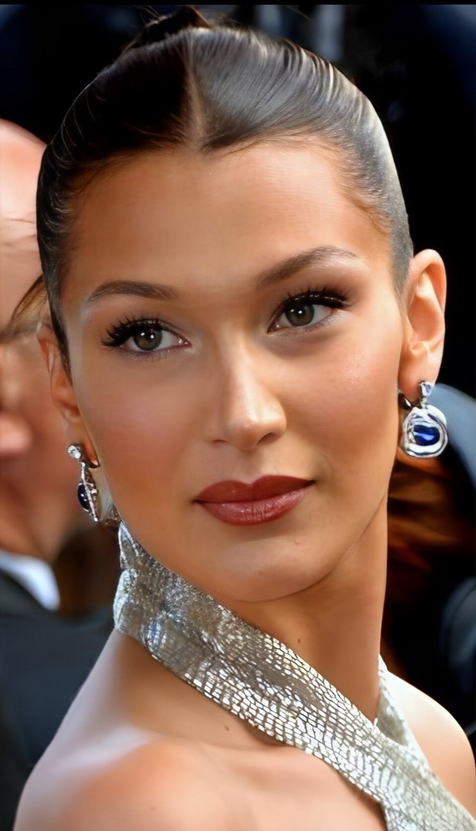 Bella Hadid wearing silver halter and sapphire earrings at Cannes 2018