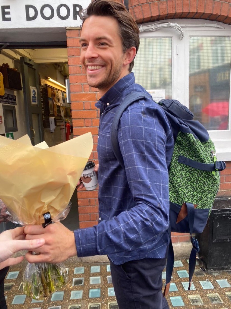 Jonathan Bailey: Check shirt and green backpack