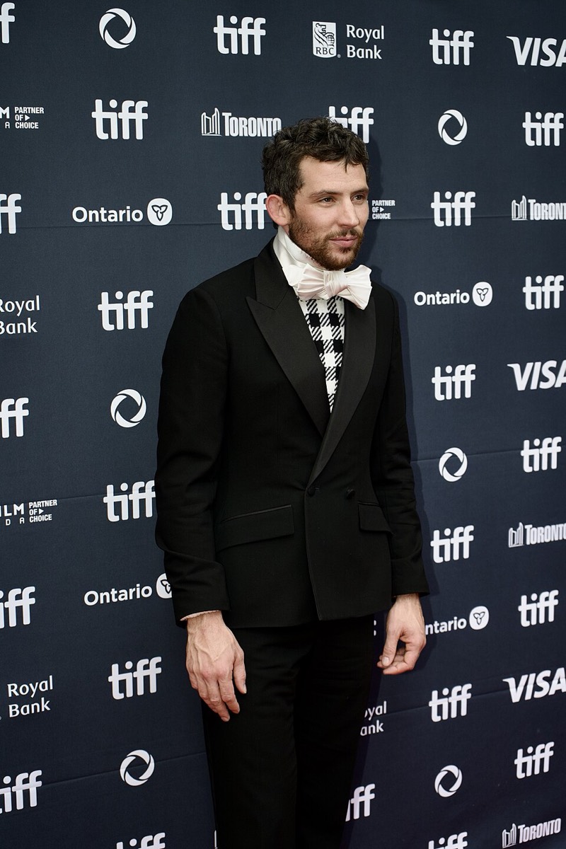 Josh O'Connor wearing double-breasted tuxedo and cravat at Toronto Film Festival 2025