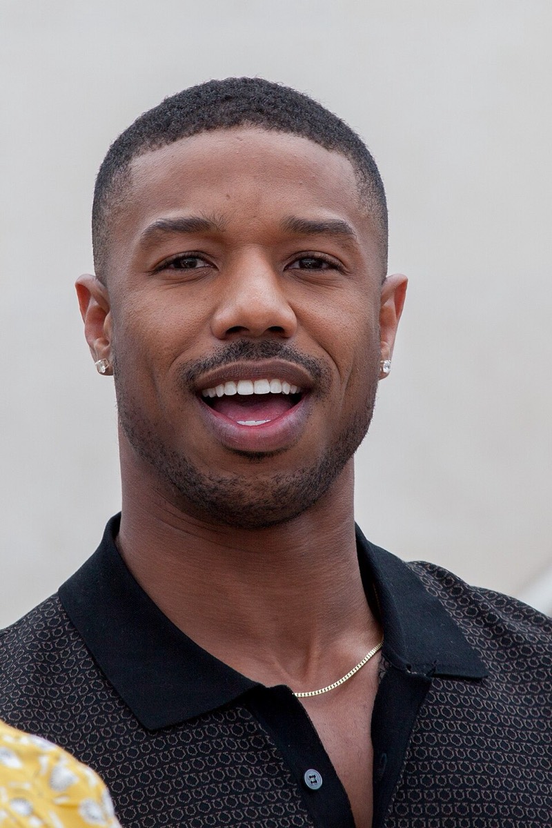 Michael B. Jordan: Black knit polo and fine chain