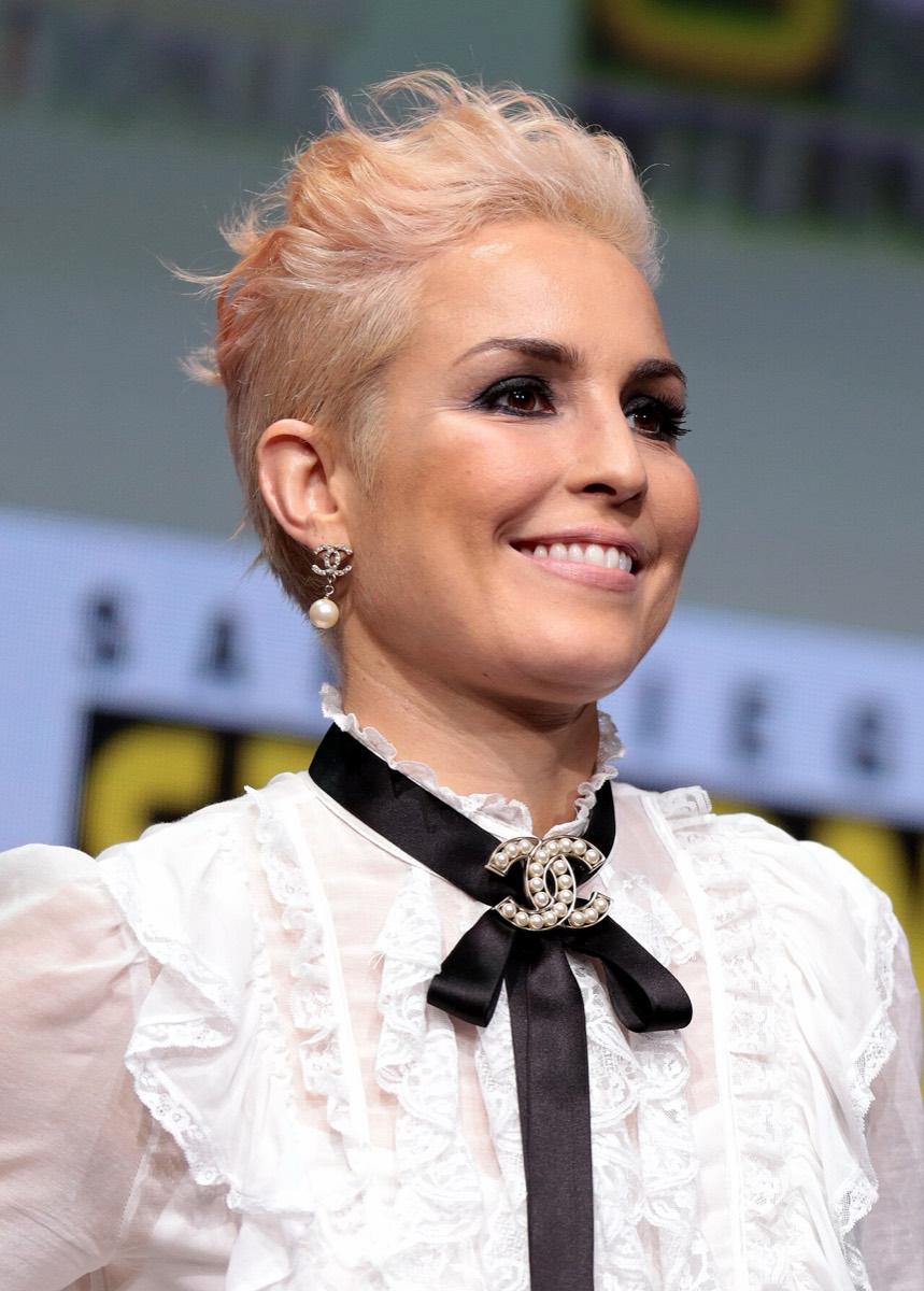 Noomi Rapace wearing white lace blouse and black bow at Comic-Con 2017